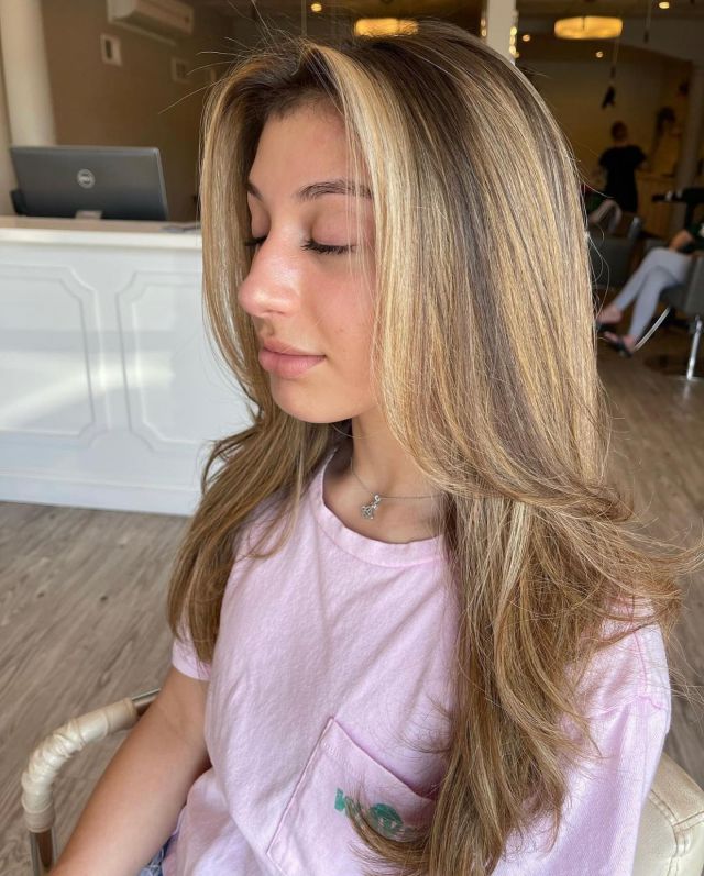 Layered highlighted hair styled at Neau Salon